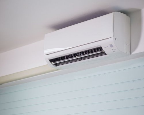 technician cleaning a wall mounted air conditioner in Cairo
